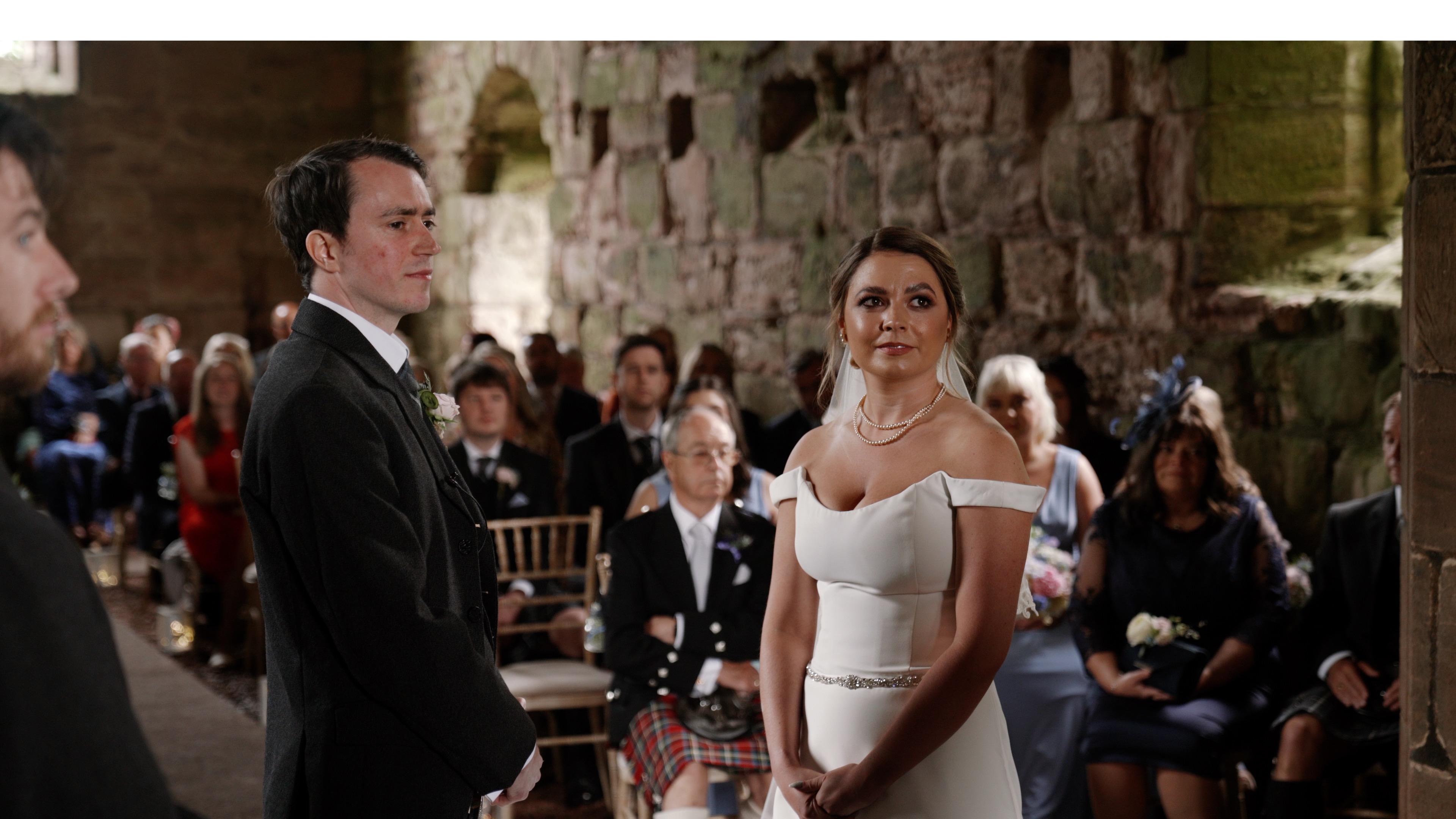 Vikki and David, husband and wife standing in the church during the ceremony